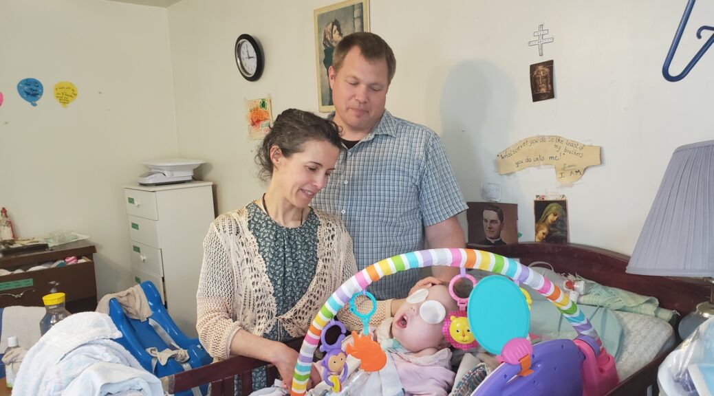 Image of parents and little angie with special needs